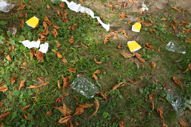 Photo of Garbage on grass in park, above view