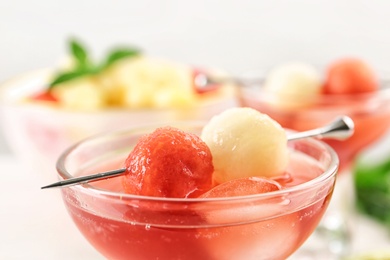 Glass of melon and watermelon ball cocktail on table, closeup