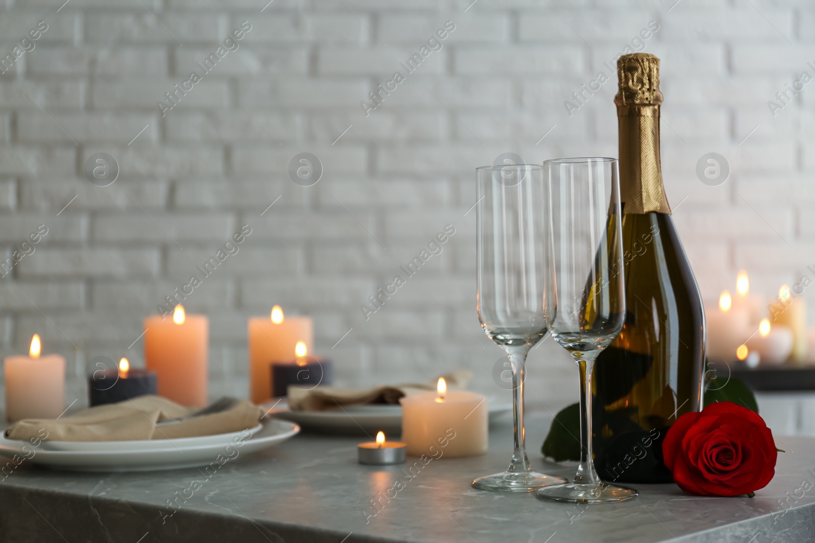 Photo of Romantic table setting with burning candles indoors