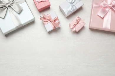 Photo of Beautiful gift boxes on white table, flat lay. Space for text