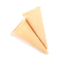 Empty crispy waffle cones for ice cream on white background, top view