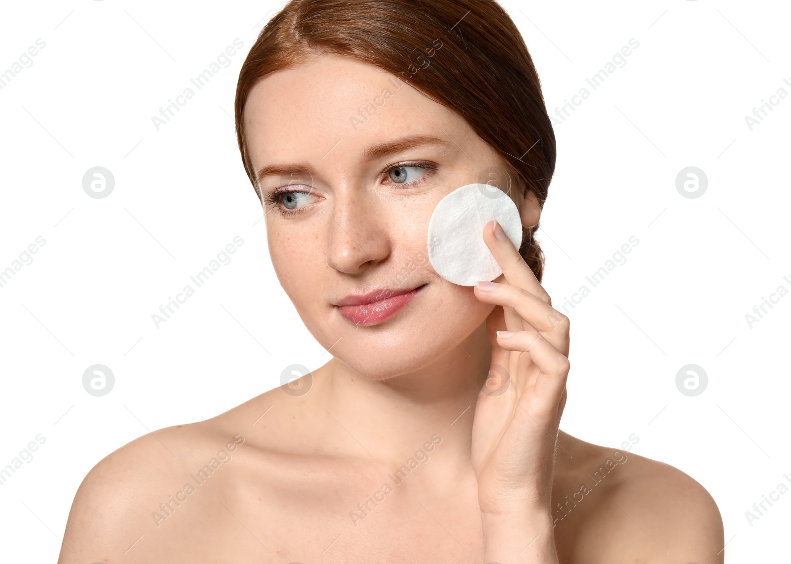 Photo of Beautiful woman with freckles holding cotton pad on white background