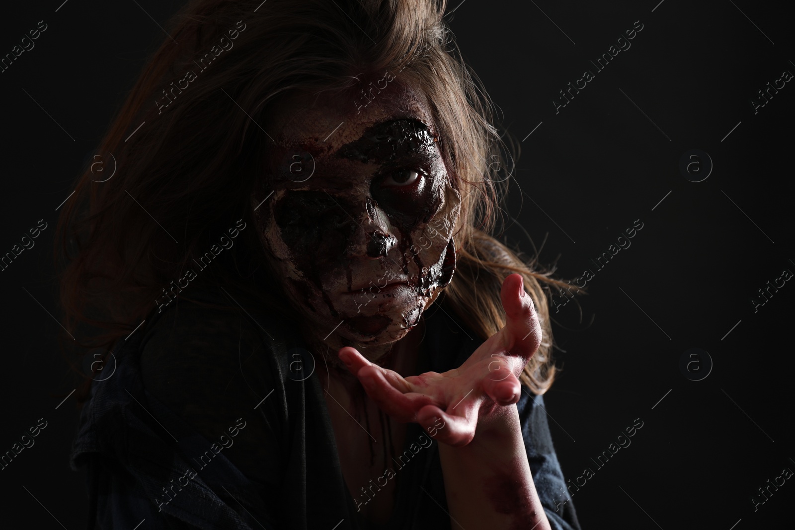 Photo of Scary zombie on dark background. Halloween monster