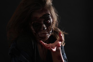 Photo of Scary zombie on dark background. Halloween monster