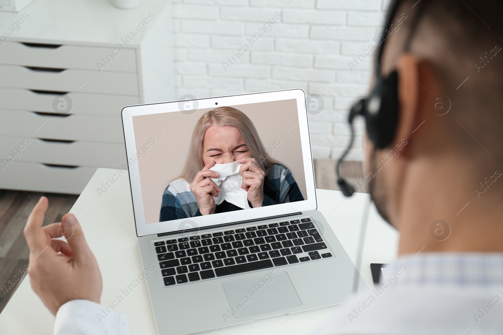 Image of Hotline service. Doctor consulting patient online via laptop indoors