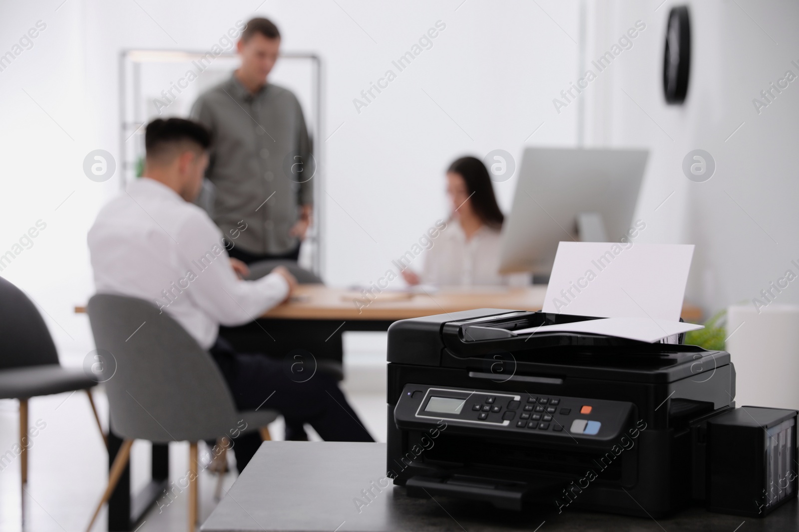 Photo of New modern printer on table in office. Space for text