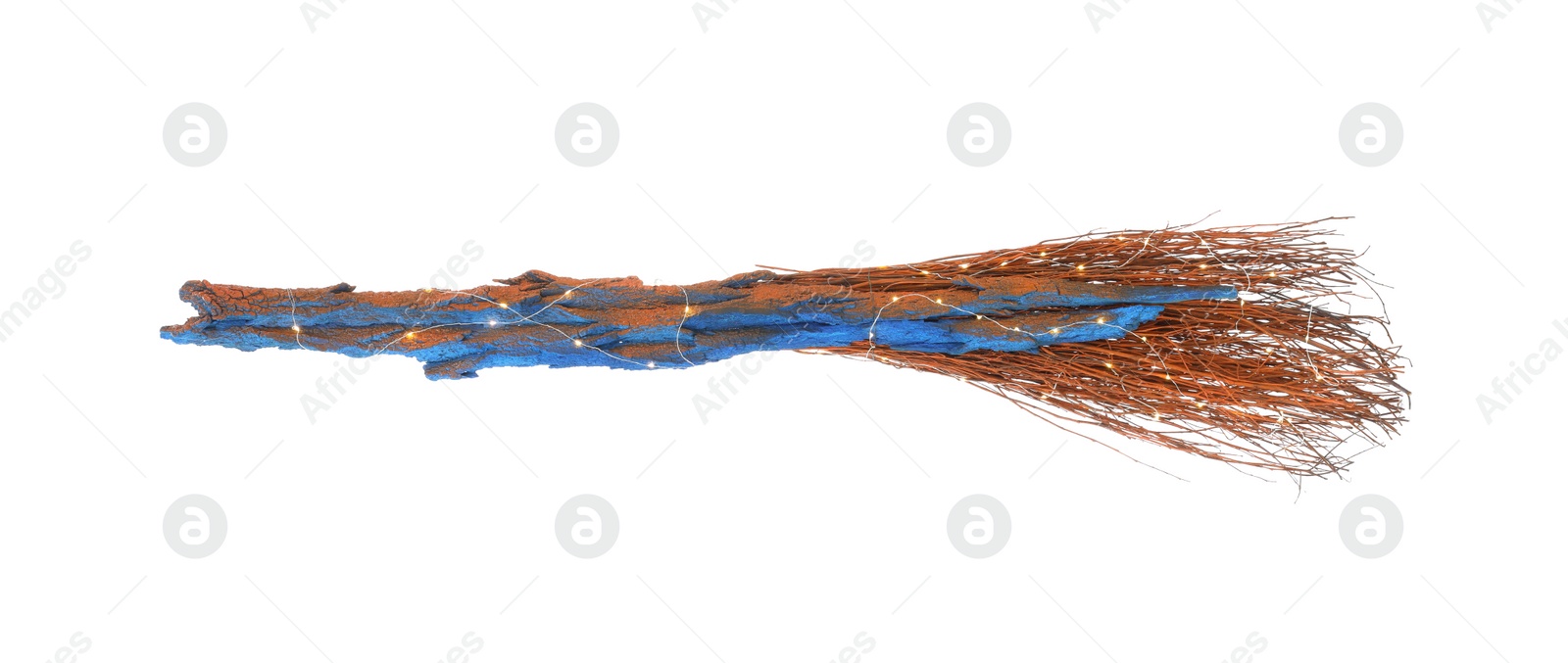 Photo of One old witch's broom with fairy lights isolated on white