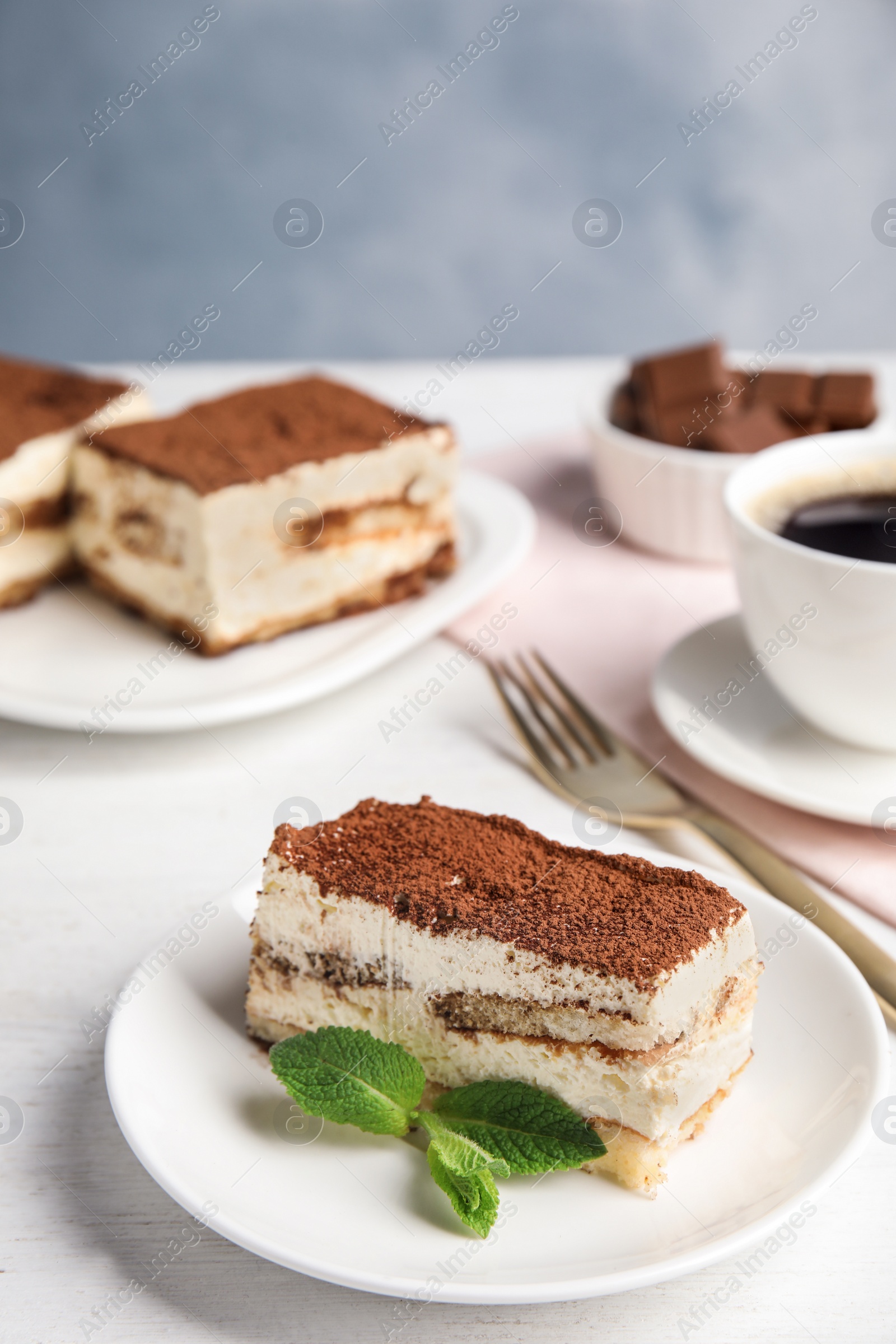 Photo of Tiramisu cakes and drink served on table