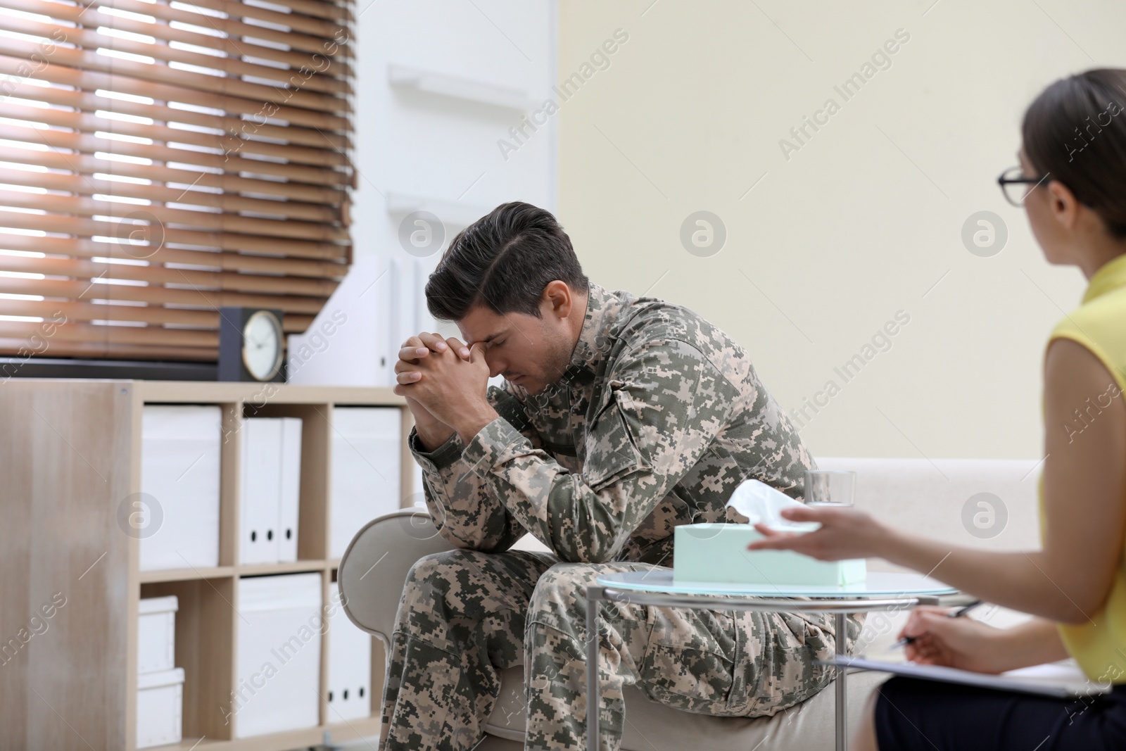 Photo of Male military officer having appointment with psychotherapist in office