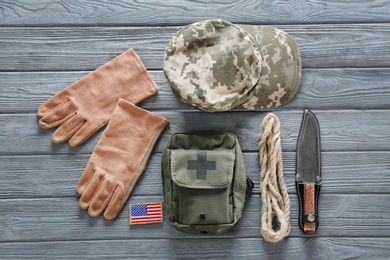 Set of military outfit on dark wooden background, flat lay