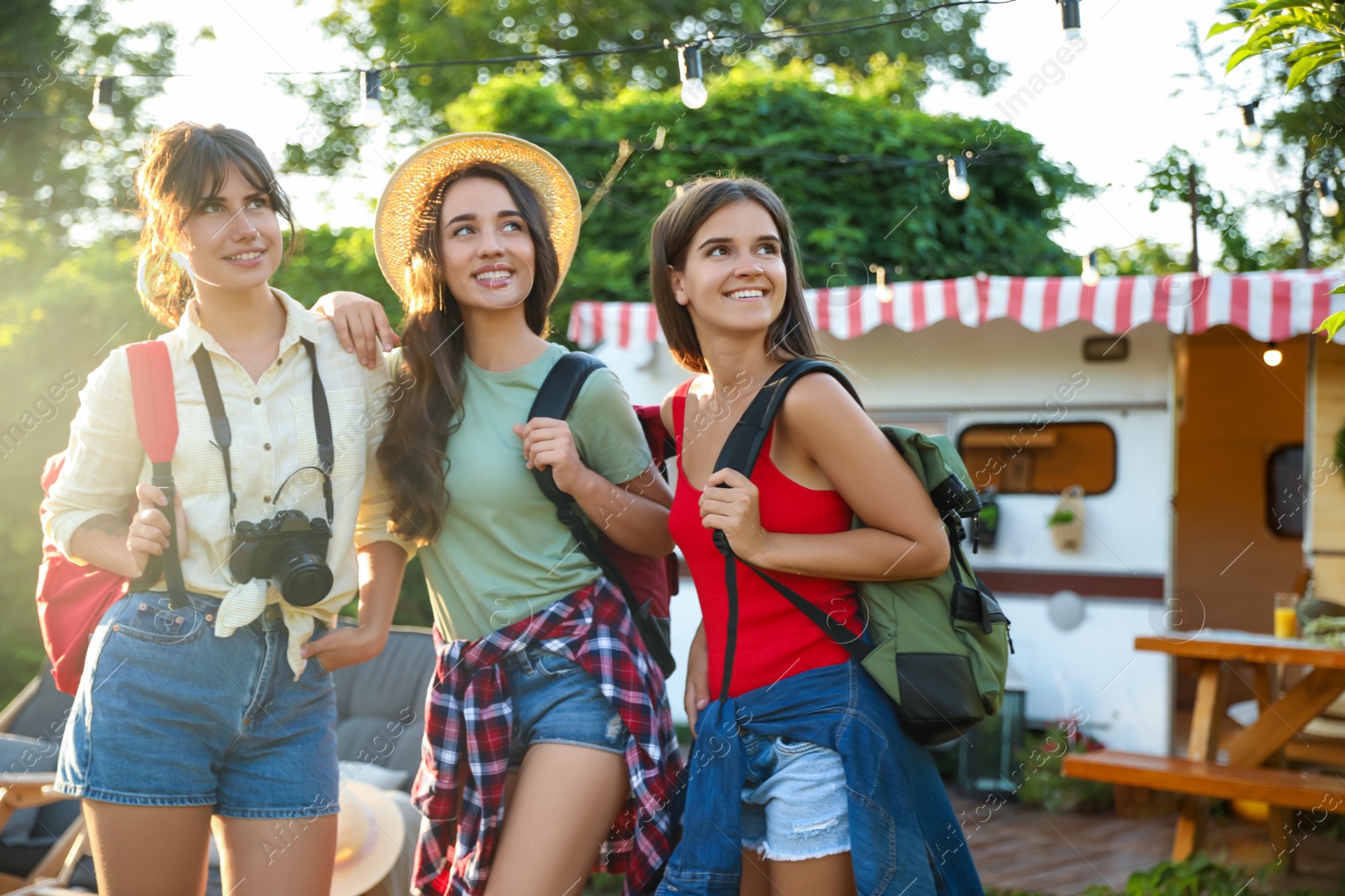 Photo of Young travelers with backpacks and camera outdoors. Summer trip