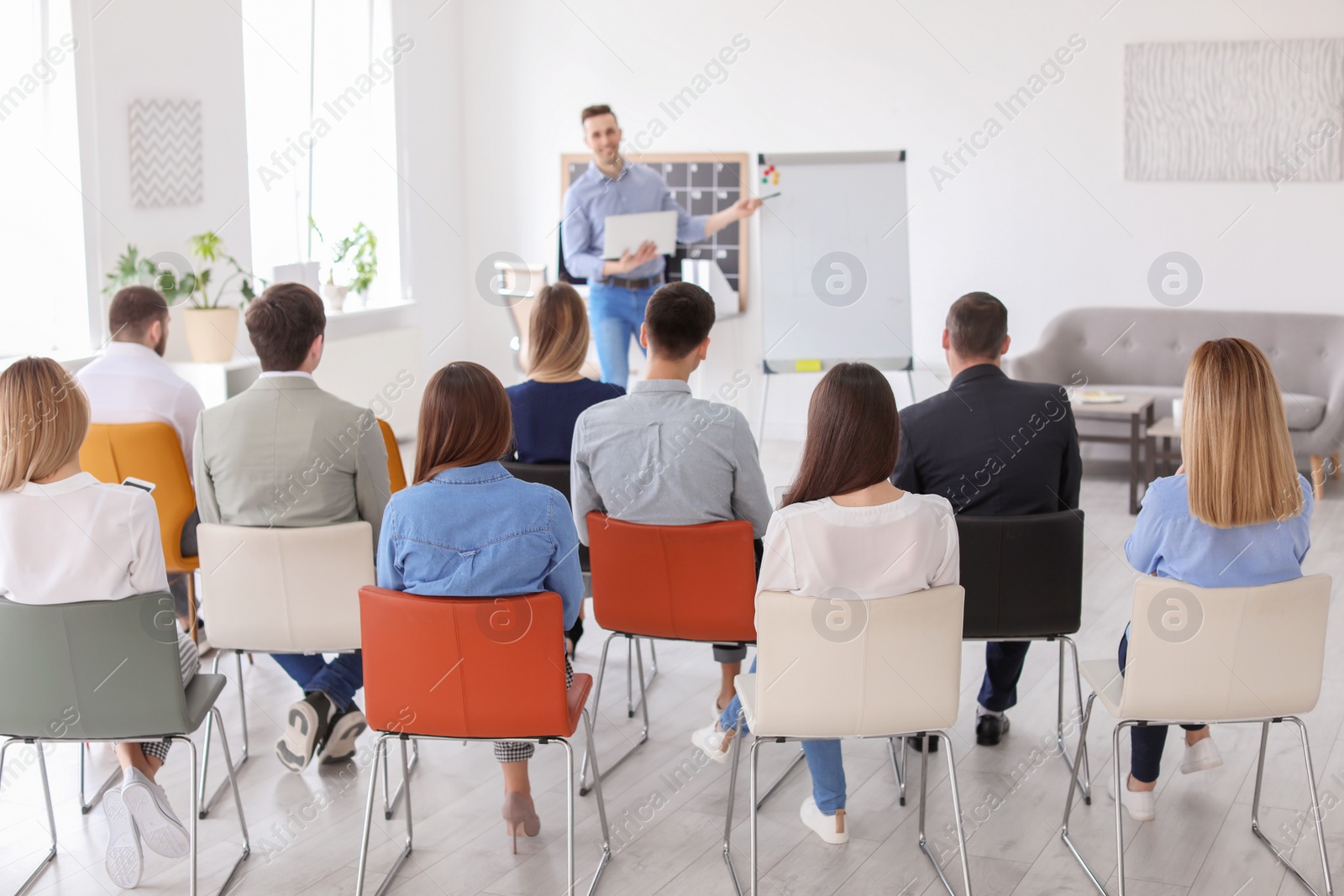 Photo of Male business trainer giving lecture in office