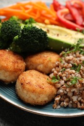 Photo of Delicious vegan bowl with cutlets, buckwheat and broccoli on grey table, closeup