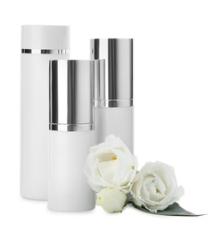 Different cosmetic products and fresh flowers on white background