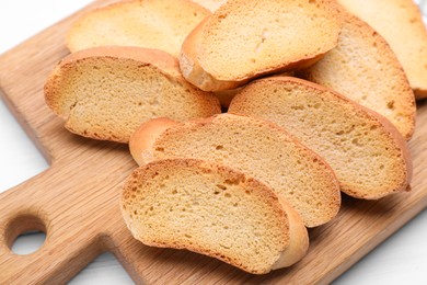 Photo of Tasty hard chuck crackers on white wooden table