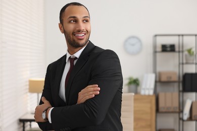 Photo of Portrait of smiling young man in office, space for text. Lawyer, businessman, accountant or manager