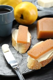 Photo of Tasty sandwiches with quince paste served on table