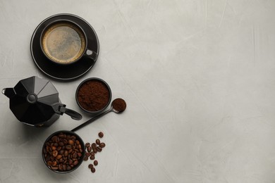 Photo of Flat lay composition with coffee grounds and roasted beans on light table, space for text