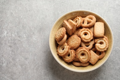 Photo of Bowl with Danish butter cookies on grey background, top view. Space for text