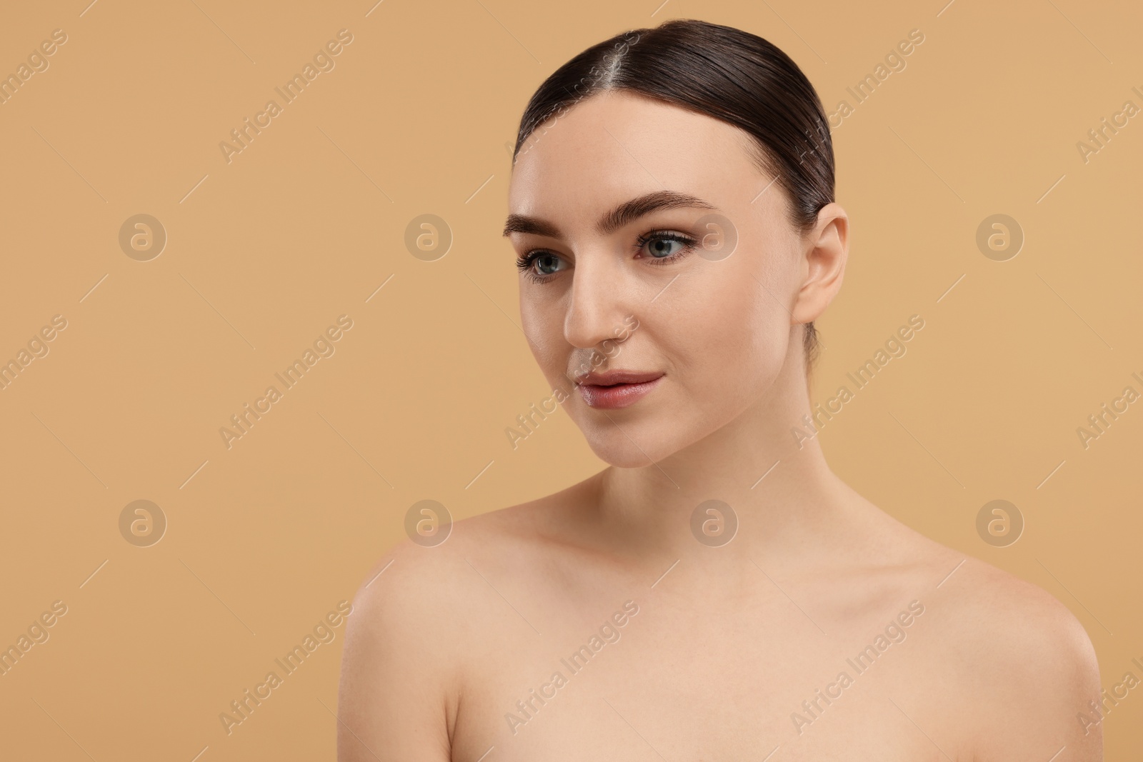 Photo of Portrait of beautiful woman on beige background. Space for text