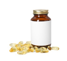 Photo of Bottle and pile of softgel capsules isolated on white