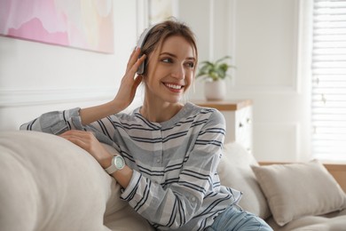 Young woman listening to music at home