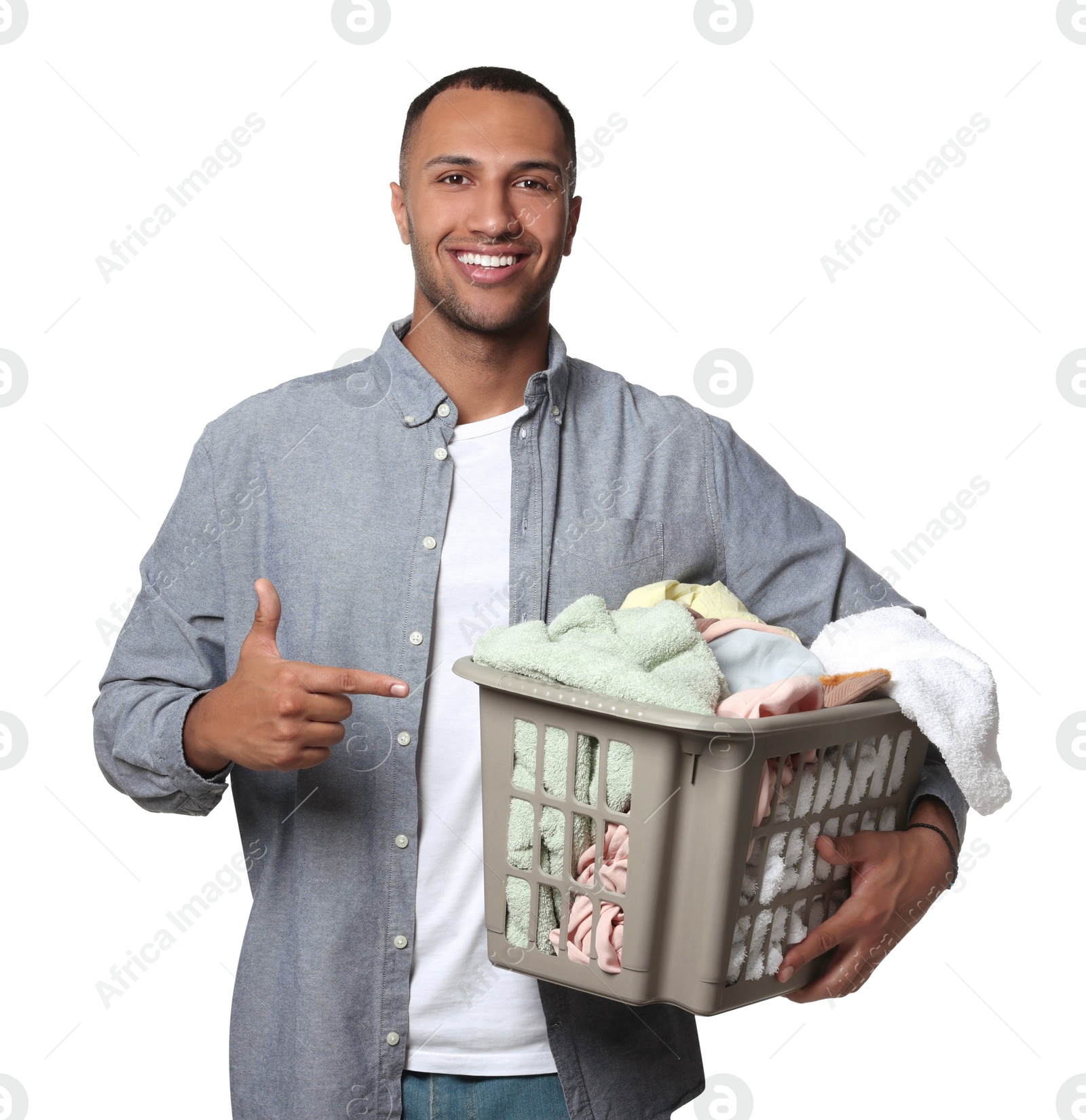 Photo of Happy man with basket full of laundry on white background