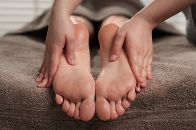 Photo of Woman receiving feet massage in spa salon, closeup