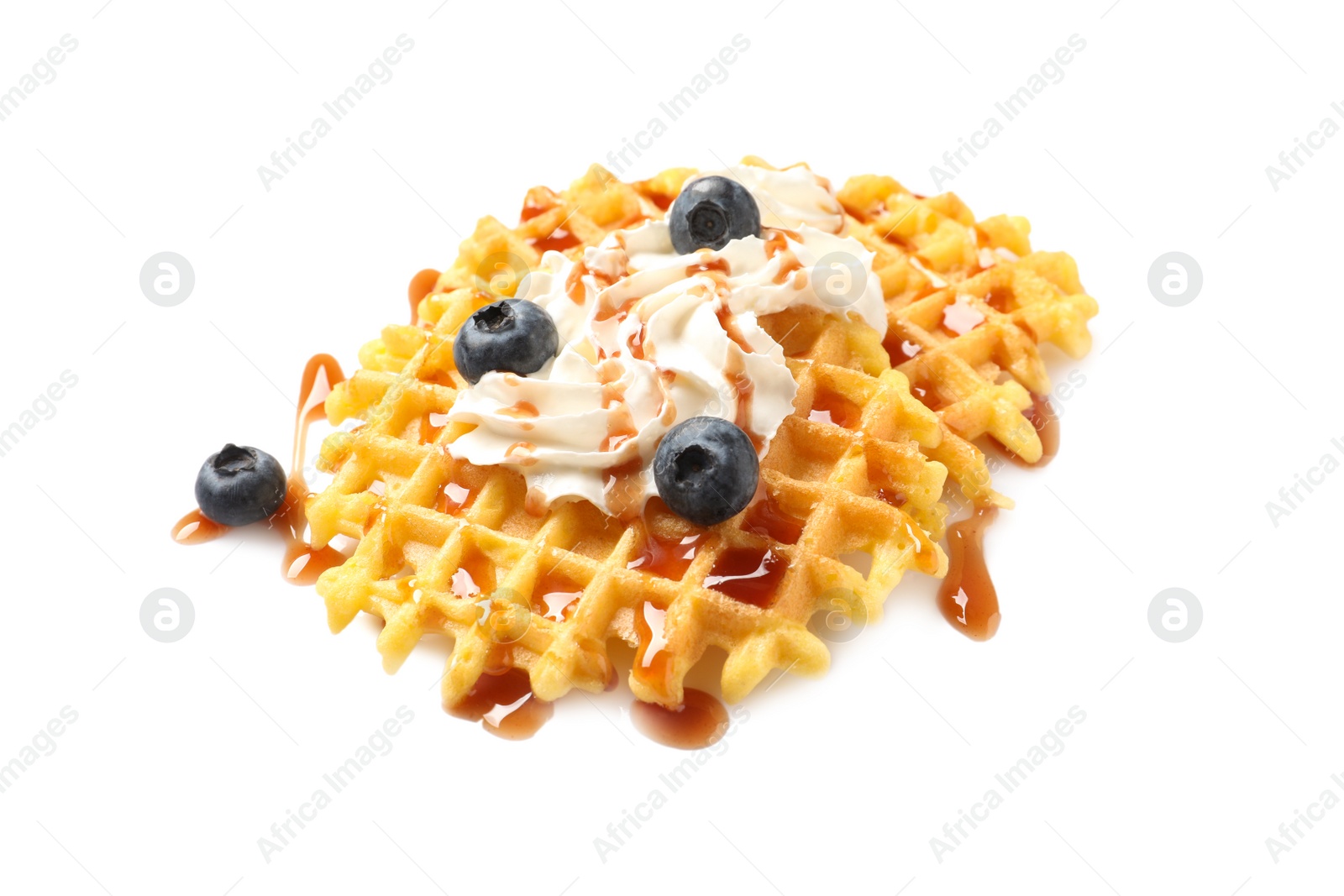 Photo of Delicious waffles with caramel syrup, whipped cream and blueberries on white background