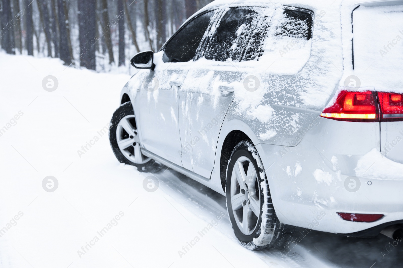 Photo of Car with winter tires on snowy road outdoors, space for text