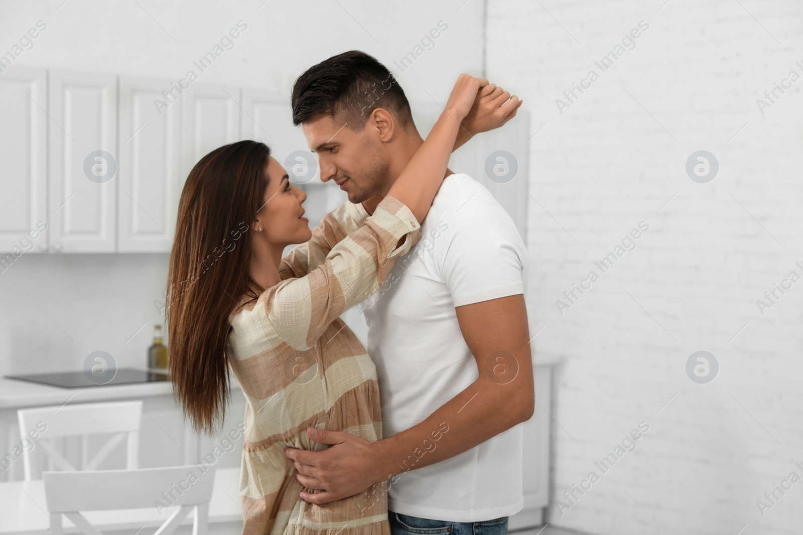 Photo of Happy couple dancing in kitchen at home