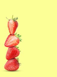 Image of Stack of fresh strawberries on light yellow background, space for text