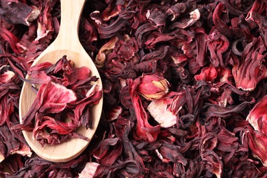 Photo of Wooden spoon with dry hibiscus tea, closeup