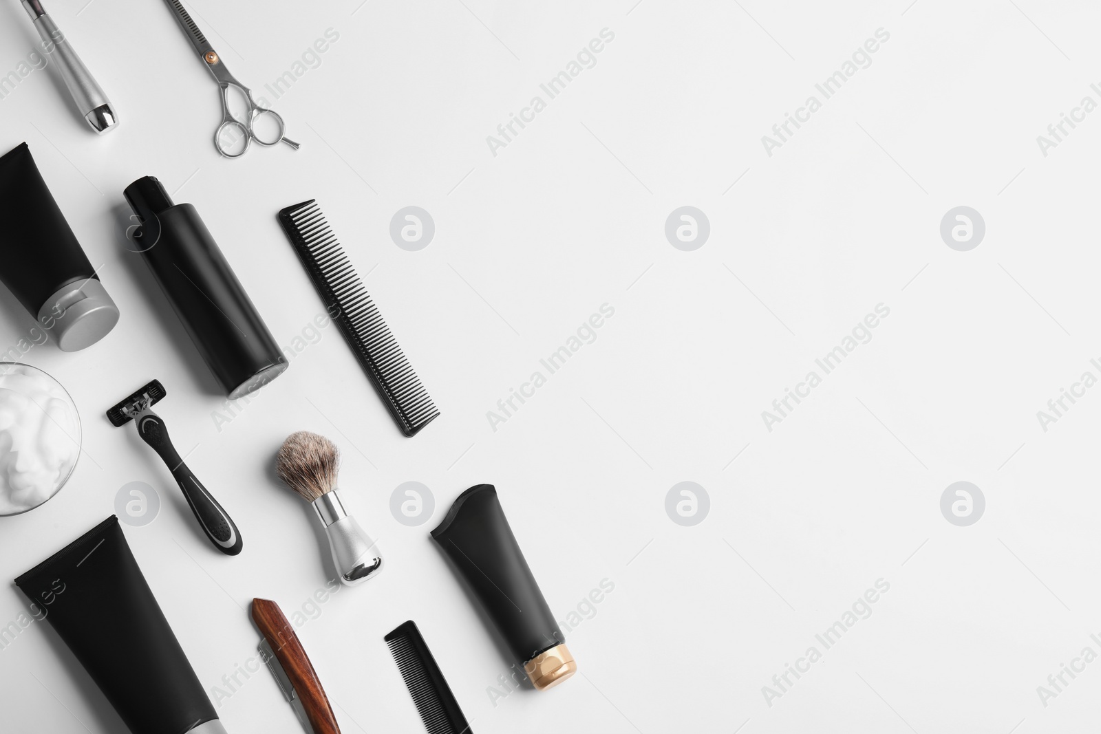 Photo of Set of barber's equipment and men's cosmetic products on light background, top view. Space for design