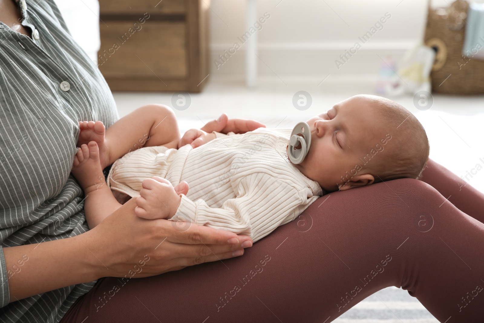 Photo of Mother with her cute sleeping baby at home, closeup