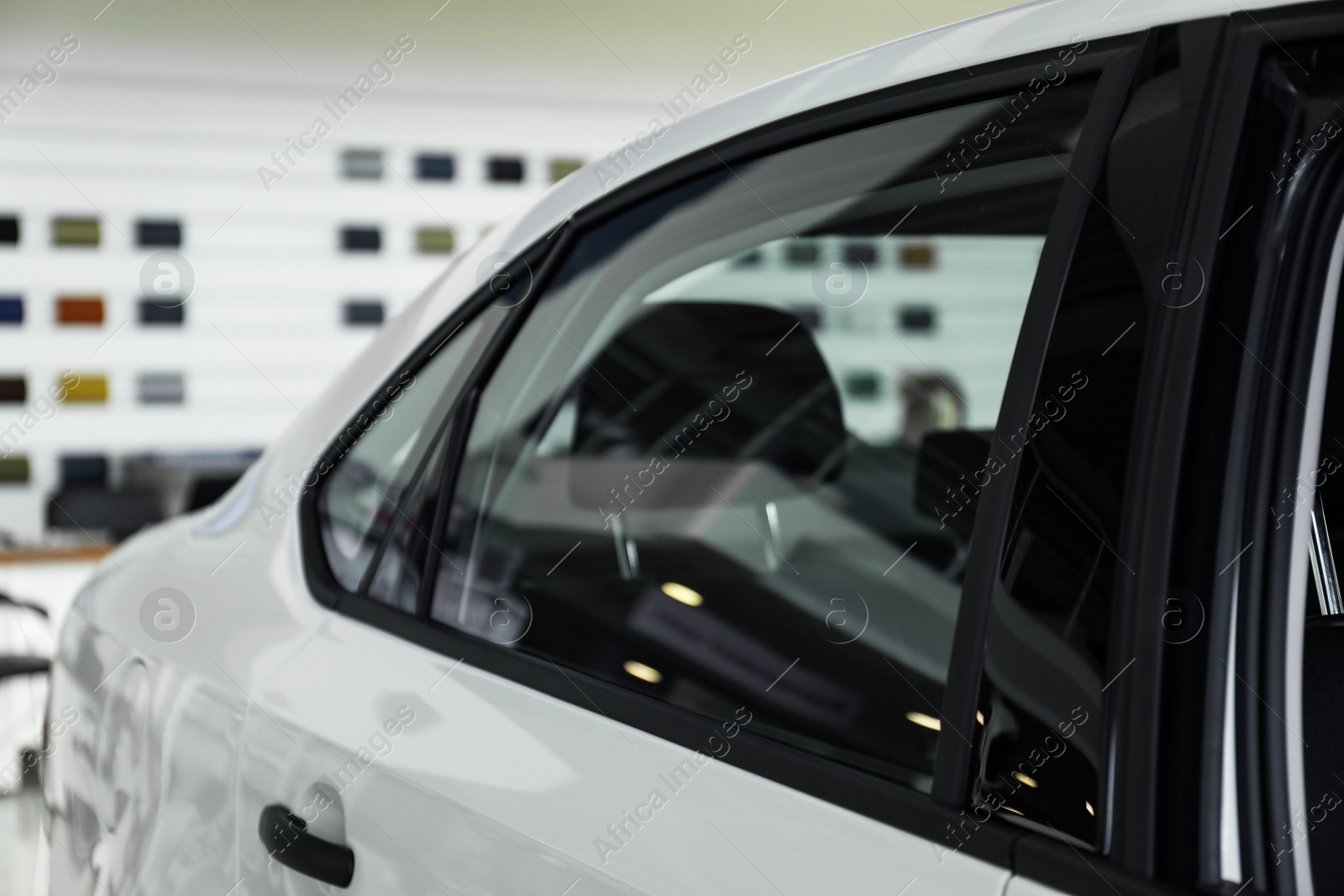 Photo of Modern car with tinting foil on window, closeup