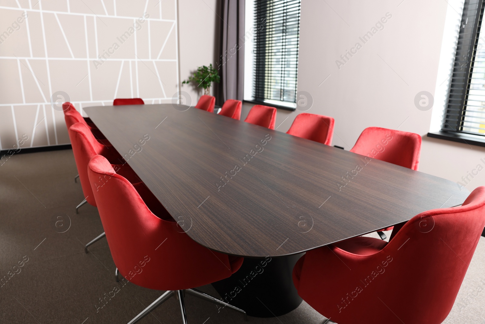 Photo of Empty conference room with stylish red office chairs and large wooden table