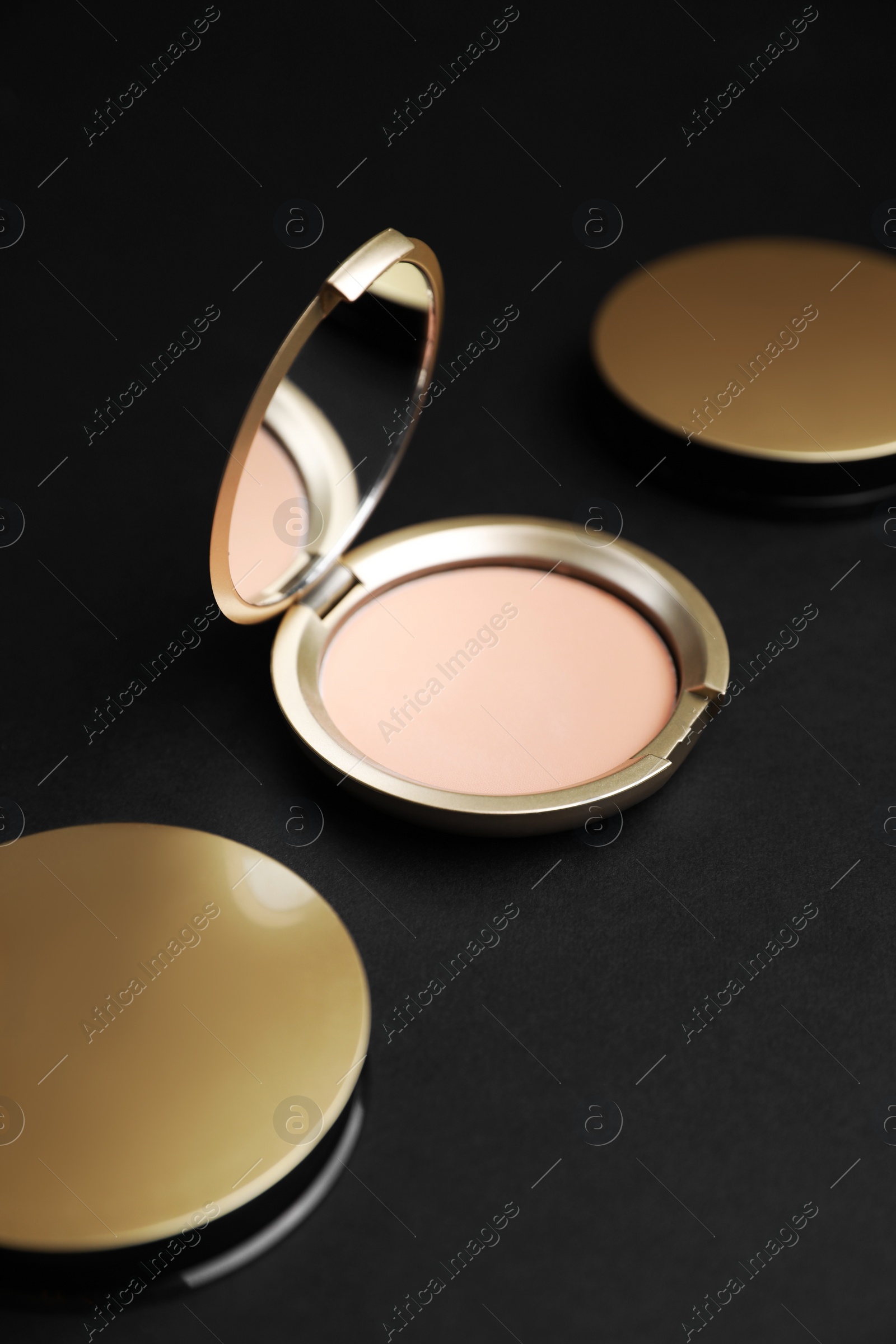 Photo of Open face powder with mirror on black background