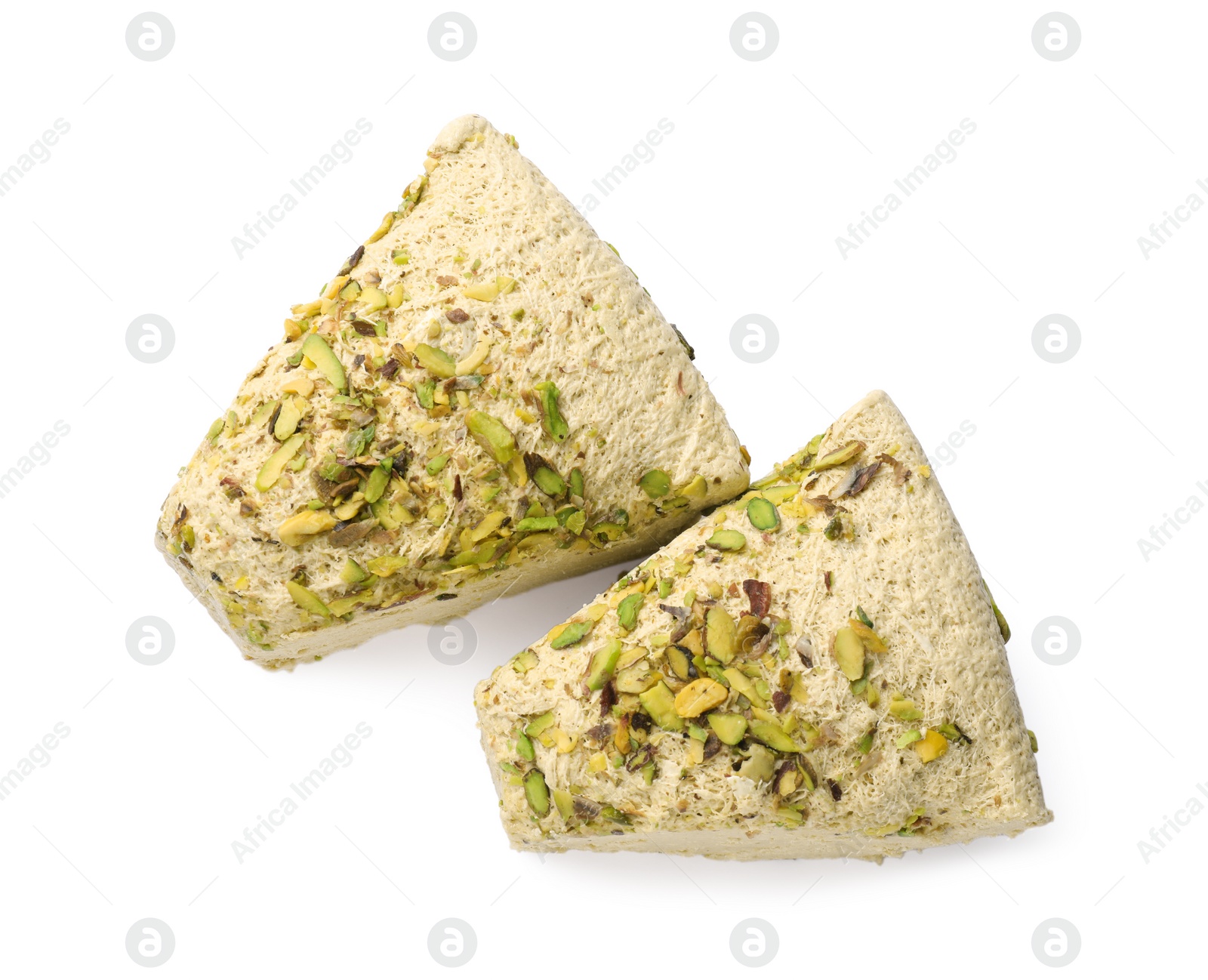 Photo of Pieces of tasty halva with pistachios on white background, top view