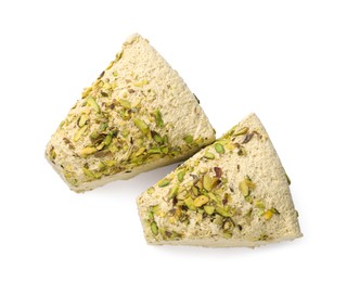 Photo of Pieces of tasty halva with pistachios on white background, top view