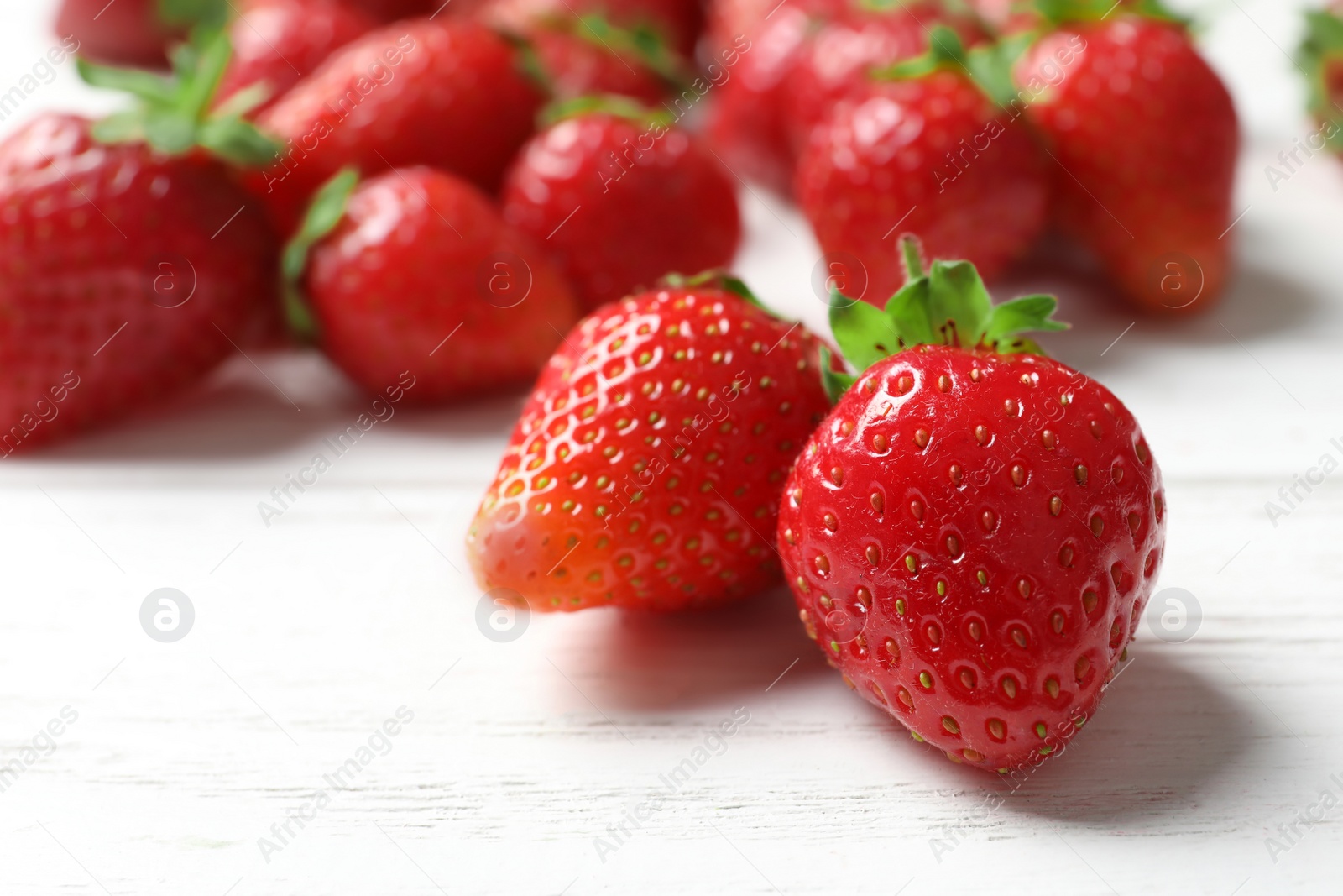 Photo of Ripe red strawberries on light background, closeup