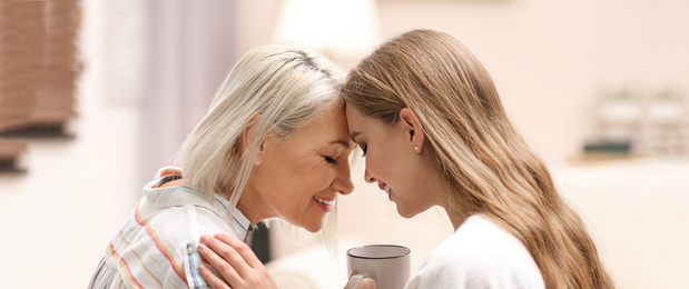 Image of Mother and her adult daughter spending time together at home. Banner design