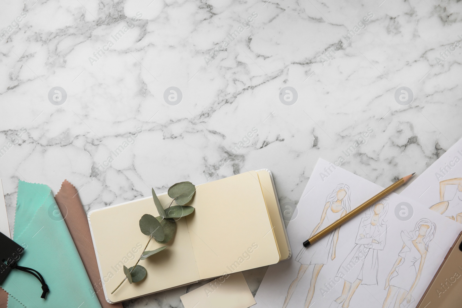 Photo of Flat lay composition with sketches and notebook on white marble table, space for text. Designer's workplace