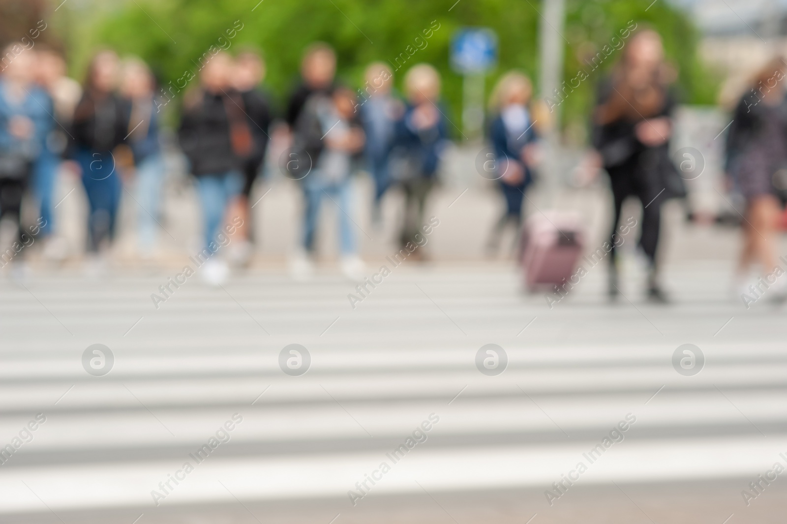 Photo of People crossing street in city, blurred view