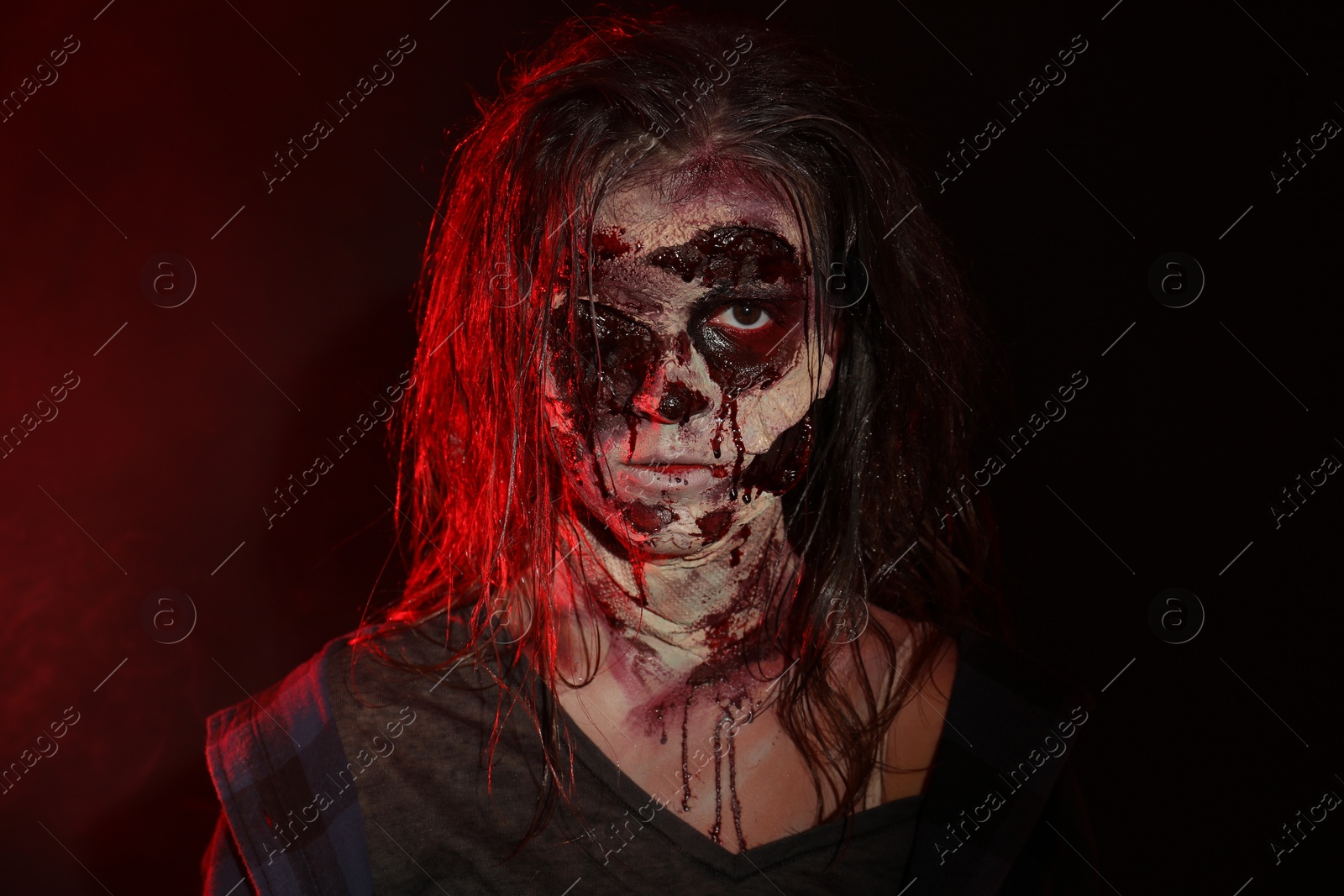 Photo of Scary zombie on dark background. Halloween monster