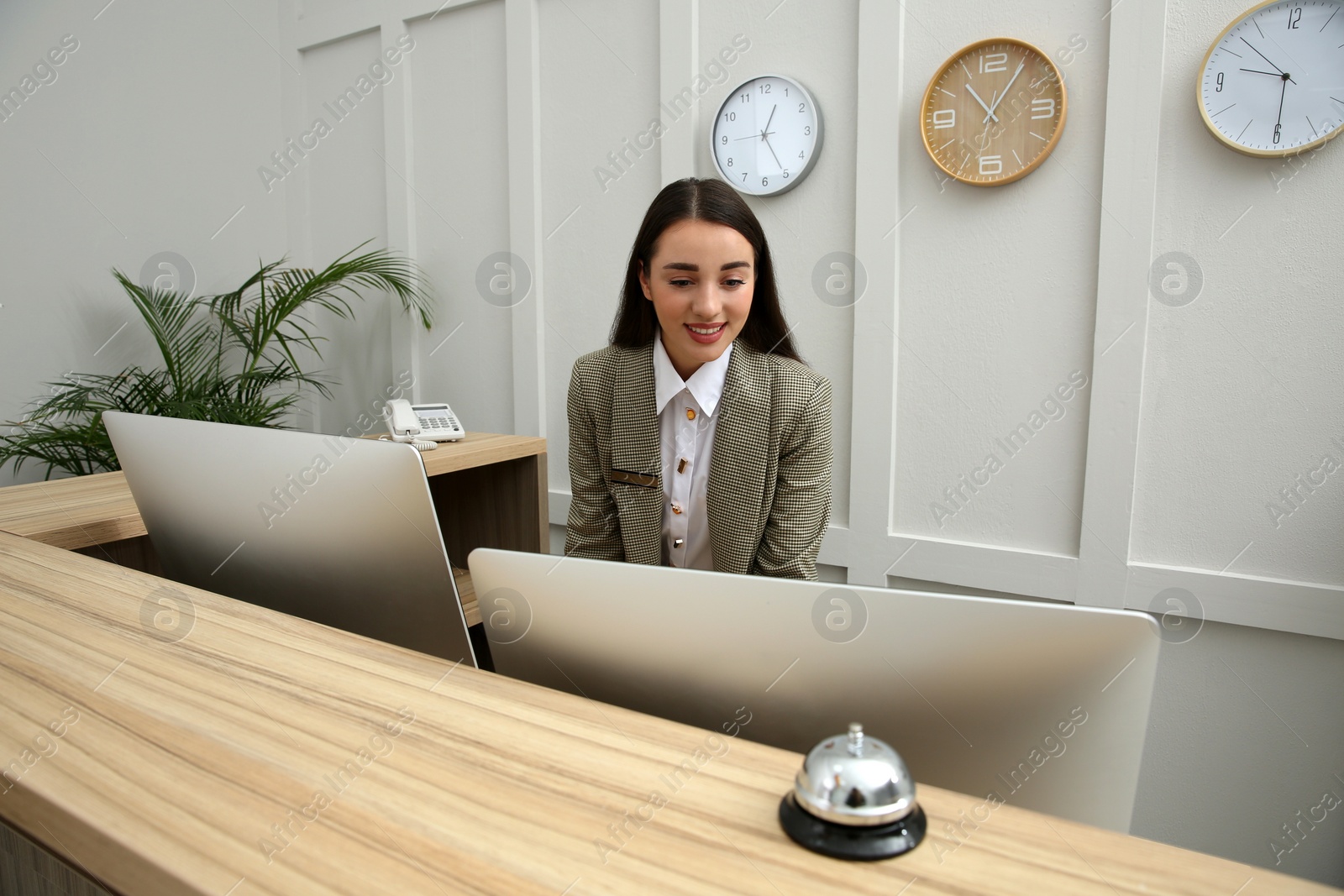 Photo of Beautiful receptionist working at counter in hotel