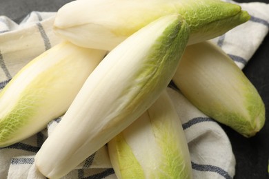 Photo of Fresh raw Belgian endives (chicory) on black table