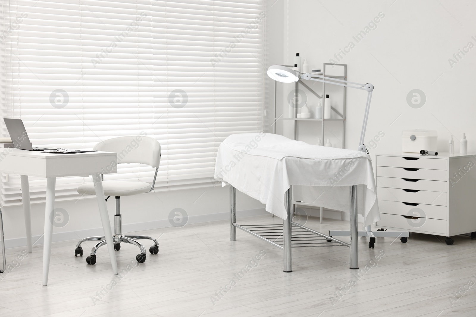 Photo of Modern interior of dermatologist's office with examination table
