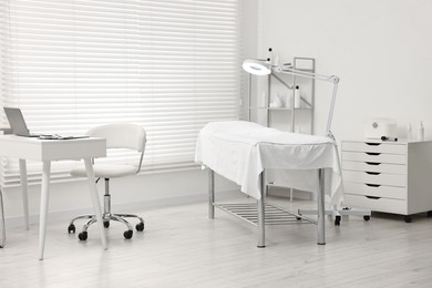 Modern interior of dermatologist's office with examination table