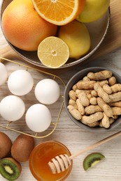 Allergenic food. Different fresh products on light wooden table, top view